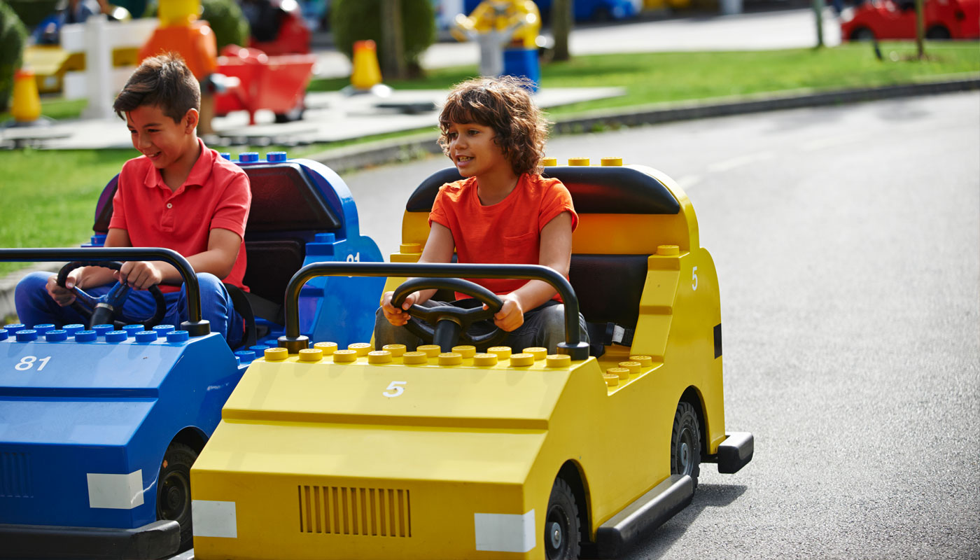 Boys driving cars on LEGO® City Driving School at LEGOLAND® Windsor Resort